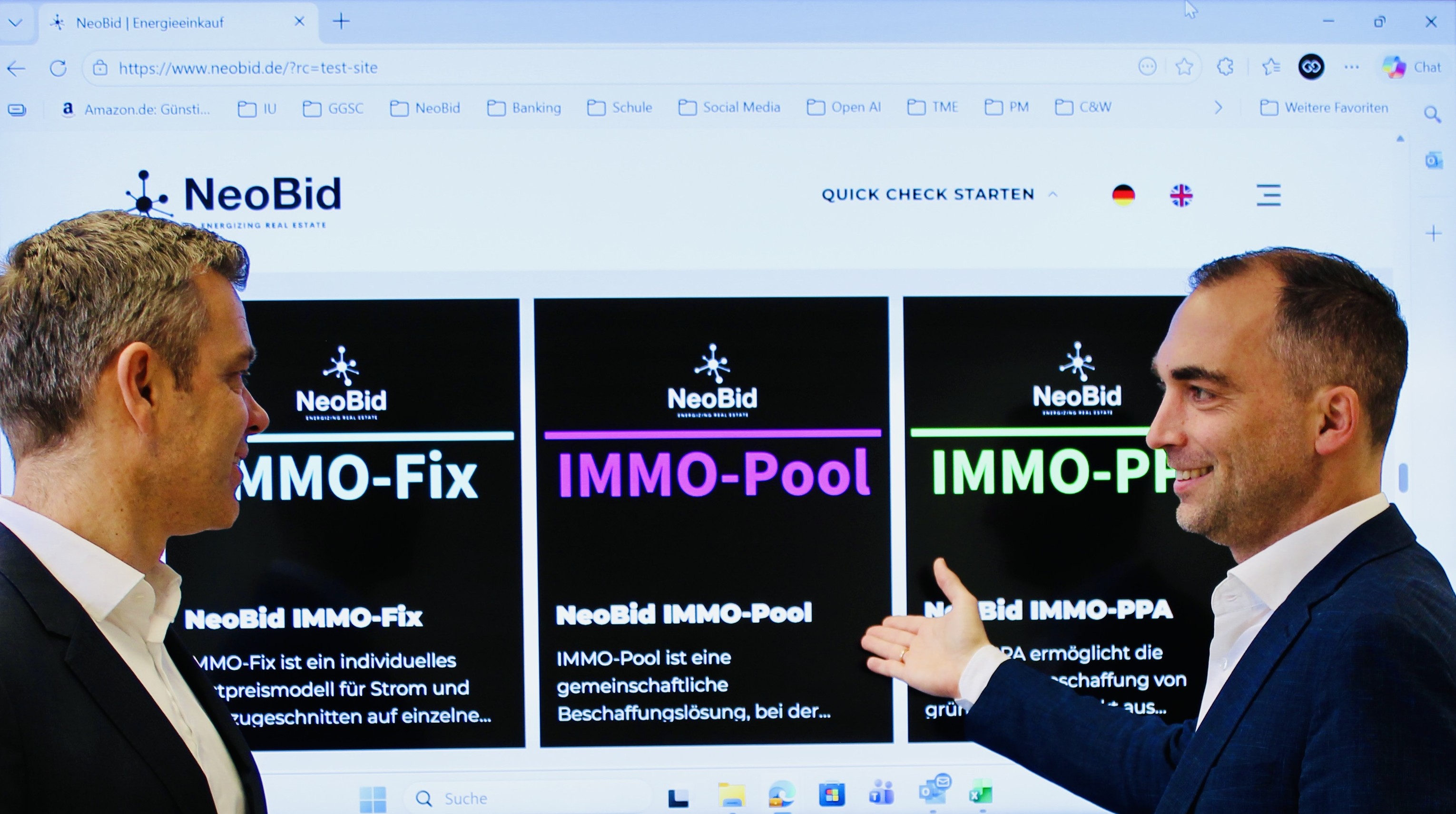 The two NeoBid founders in conversation in front of the NeoBid website